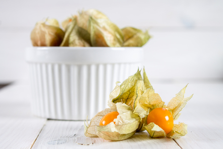 Exotic berries physalis on a white wooden tableの写真素材