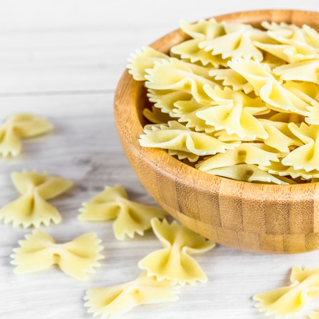 Dried italian bowtie pasta or farfalle. A square image.の写真素材