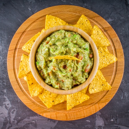 nachos with guacamole on a gray background.の写真素材