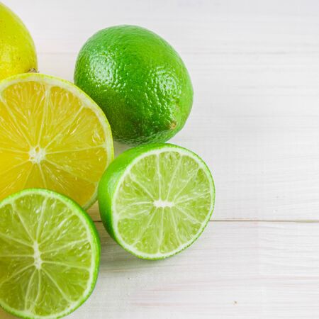 lemons and limes on a wooden background.の写真素材