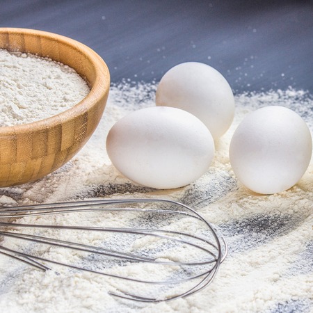 Eggs, flour and milk on a gray background.の写真素材
