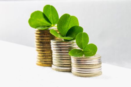 Stacks of Russian coins with clover leaves on a gray background with droplets of water. St.Patrick 's Dayの写真素材
