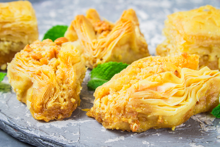 Jewish, turkish, arabic traditional national dessert. Macro. Selective focus. Baklava with honey and nutsの写真素材