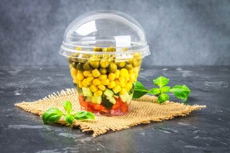 Healthy homemade salad in a jar with vegetables, cucumbers, tomatoes, peas and corn - Healthy diet, detox, pure food or vegetarian conceptの写真素材