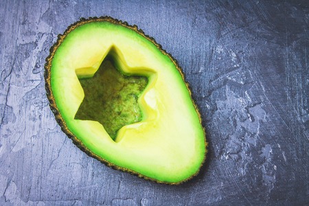 Sandwiches from bread with slices, zvezdami, hearts from avocado and curd cheese on a gray dark marble background.の写真素材