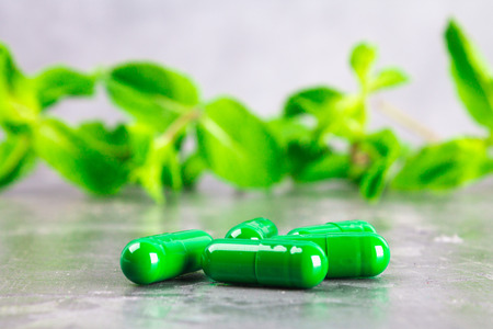 Multicolored pills close-up on a gray concrete background. Selective focus.の写真素材