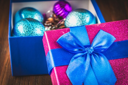Box with Christmas toys on a wooden background.の写真素材