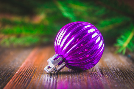 toy balls on the background of Christmas tree branches on a wooden background.の写真素材