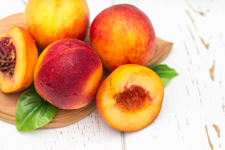 a lot of fresh peaches on a white tableの写真素材