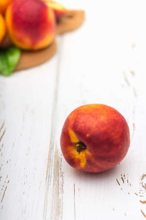 a lot of fresh peaches on a white tableの写真素材
