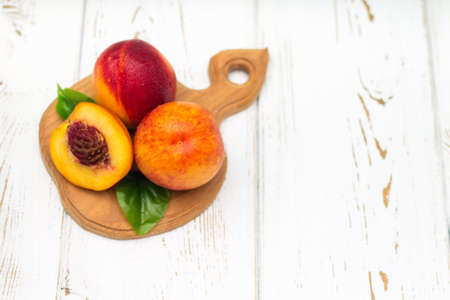 a lot of fresh peaches on a white table. Top view.の写真素材