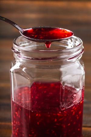 Homemade jam with raspberry on the wooden tableの写真素材