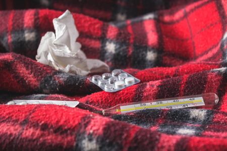 Drugs for colds - pills, spray. Folk remedies - lemon, tea, raspberry jam. Thermometer, handkerchiefs. Treatment of illness, influenza.の写真素材