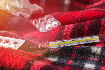 Drugs for colds - pills, spray. Folk remedies - lemon, tea, raspberry jam. Thermometer, handkerchiefs. Treatment of illness, influenza.の写真素材