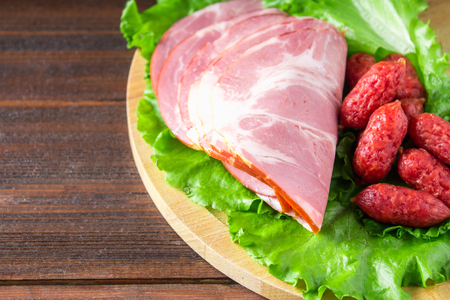 Assorted meat products including ham and sausages.の写真素材