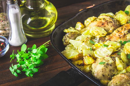 Roasted chicken leg with potatoes with caraway and garlic.の写真素材