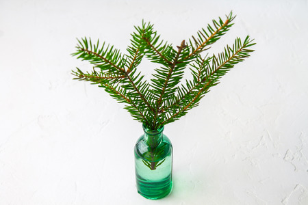 Christmas decorations on the table, spruce branch in the bottleの写真素材
