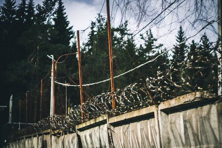 Barbed wire. Barbed wire on fence with blue sky to feel worryingの写真素材