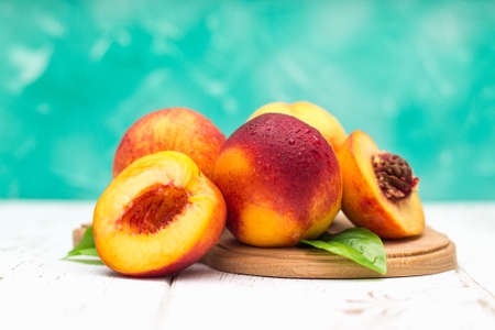 a lot of fresh peaches on a white tableの写真素材