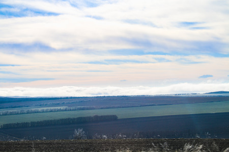 Grass in frost after frosts against the blue sky, fields and mountainsの写真素材