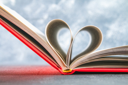 The pages of the book in the red cover are made in the form of a heart. The concept of Valentine's Dayの写真素材
