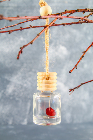Red heart in a small glass jar on a gray concrete background. The concept of Valentine's Day. A symbol of loveの写真素材