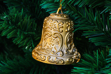 Toy bell on a Christmas tree. Element of the New Year's holiday