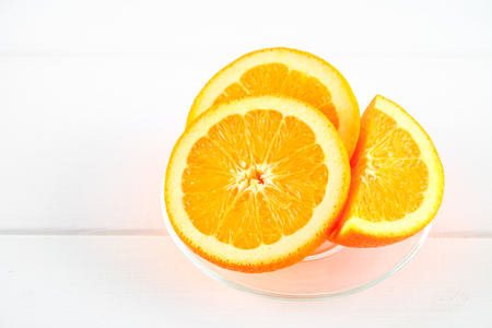 Orange slices on a white wooden table. Healthy food, drinks