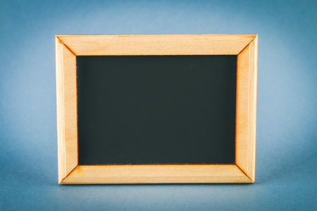 Chalkboard in a wooden frame with an empty box on a gray background. Copy the spaceの写真素材