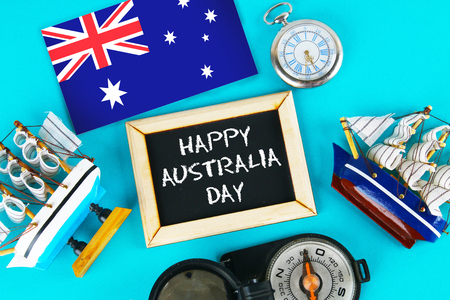 Chalkboard with the inscription: Happy day of Australia surrounded by shipwrights, a compass, a clock and an Australian flag on a blue background. 26 Januaryの写真素材