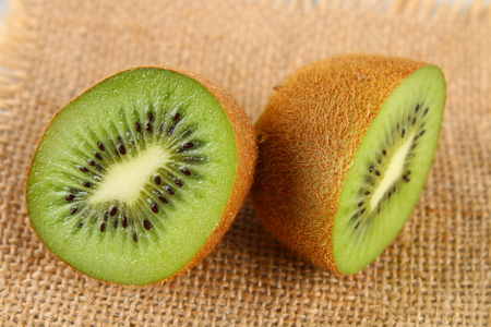 Cut into kiwi slices on a gray table. Healthy foodの写真素材