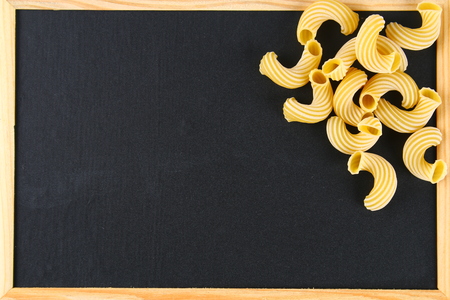 Raw Pasta Cavatappi or Cellentani on a chalkboardの写真素材