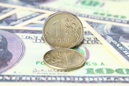 coin one ruble against the background US dollars backgroundの写真素材
