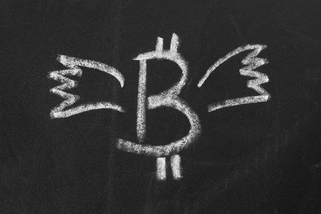 Image bitcoin with wings chalk on a chalkboardの写真素材