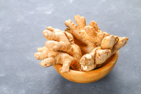 Spicy root of ginger on a wooden tableの写真素材