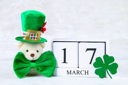 St.Patrick 's Day. A wooden calendar showing March 17. Green hat and bowの写真素材