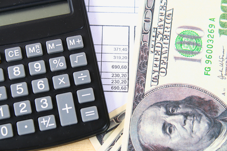Finance concept : The United States hundred-dollar bills , calculator , billsの写真素材