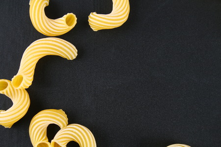 Raw Pasta Cavatappi or Cellentani on a chalkboard