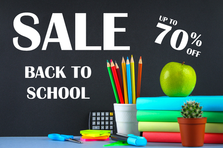 A pile of books and stationery on a chalkboard background. Work desk, education, school. SALEの写真素材