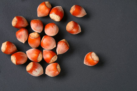 Top view of roasted peeled hazelnuts on a saturated black background.Snacks. Copy spaceの写真素材