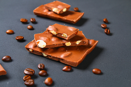 Coffee beans with chocolate on gray backgroundの写真素材