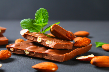 chocolate with almonds on dark grey backgroundの写真素材