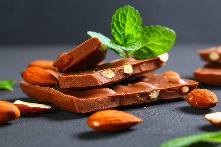 chocolate with almonds on dark grey backgroundの写真素材