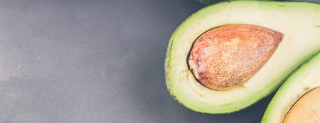 Avocado. Fresh avocado palta on black background. Guacamole ingredient. Vegetarian or healthy eating. Healthy fatの写真素材