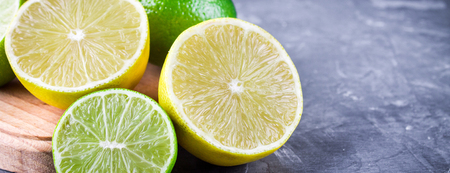 lemons and limes on a gray background.の写真素材
