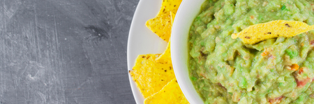 nachos with guacamole on a gray background.の写真素材