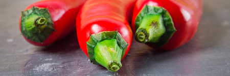 Fresh red cilli peppers isolated on gray background