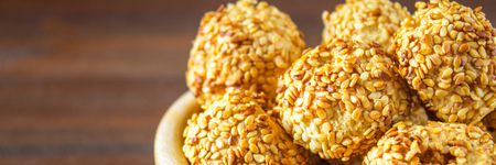 cookies with sesame seeds on a wooden tableの写真素材