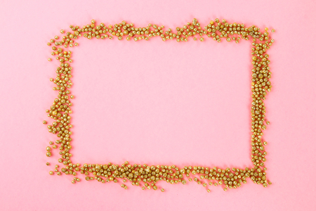 Empty space on a pastel background surrounded by shiny decorative stars and ballsの写真素材