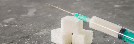Sugar in a syringe. Conceptual depiction of dependence on the sweet. Sugar is a drug. Injection of sweets.の写真素材